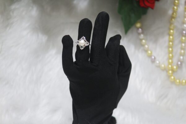 Pearl Ring with Floral Design - A stunning pearl ring featuring a delicate floral-inspired design, perfect for adding elegance and charm to any look.