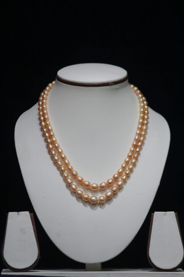 Two-Layered Golden Pearl Necklace Set - A luxurious two-layered necklace set featuring stunning golden pearls for a sophisticated and refined look.