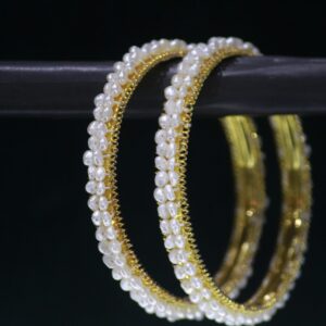Elegant pearl bangles with sophisticated design.