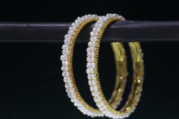 Elegant pearl bangles with sophisticated design.
