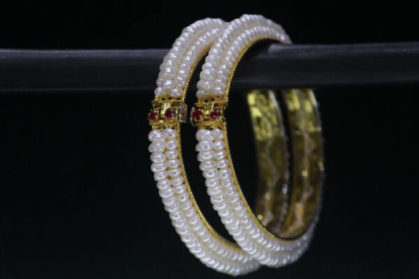 Pearl bangle set with stone accents featuring shimmering pearls complemented by sparkling gemstones, perfect for adding elegance and charm to your outfit.