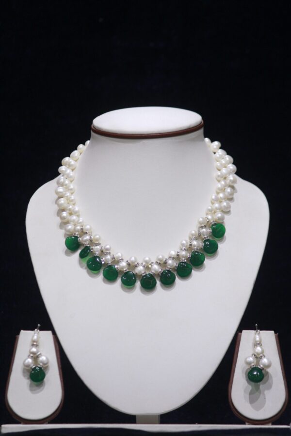 Pearl necklace set with green stone accents for a chic and vibrant look.