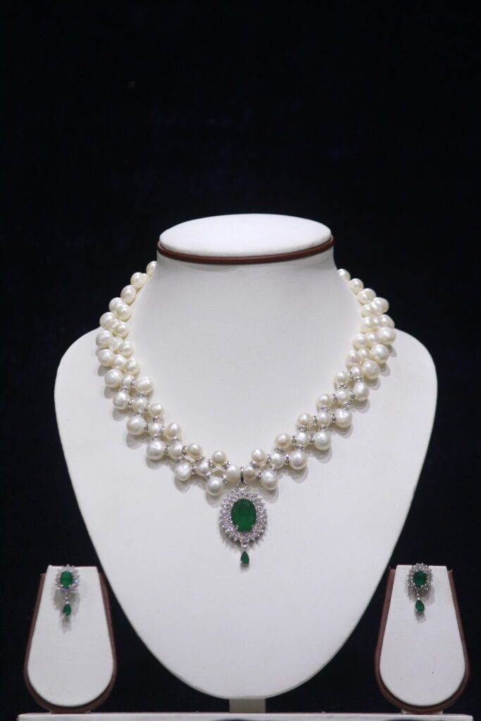 Elegant Pearl Necklace Set with Emerald Pendant, showcasing a timeless design of lustrous pearls and a vibrant green emerald pendant.