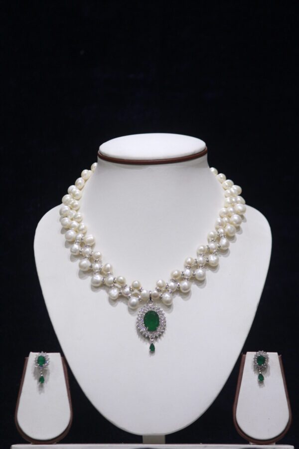 Elegant Pearl Necklace Set with Emerald Pendant, showcasing a timeless design of lustrous pearls and a vibrant green emerald pendant.