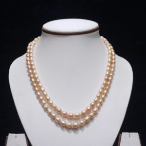 Two-layered golden pearl necklace set featuring elegant pearls and a luxurious gold design.