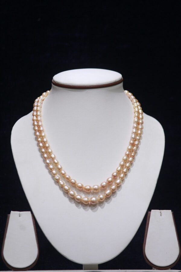 Two-layered golden pearl necklace set featuring elegant pearls and a luxurious gold design.