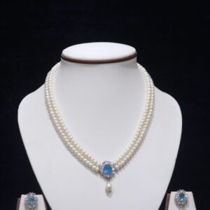 Two-layered pearl necklace set with a blue stone pendant, combining the timeless beauty of pearls and the vibrant elegance of a blue stone.