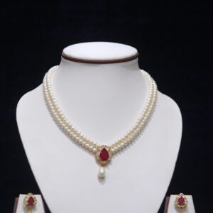 Two-layered pearl necklace set with a ruby pendant, combining classic pearls and a vibrant ruby for timeless elegance.