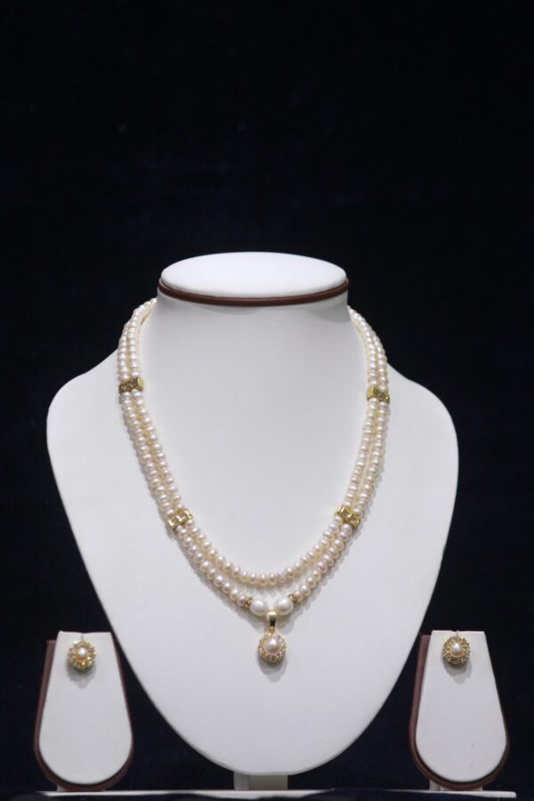 Two-layered pearl necklace set with a pearl pendant, designed for timeless elegance and sophistication, perfect for any occasion.