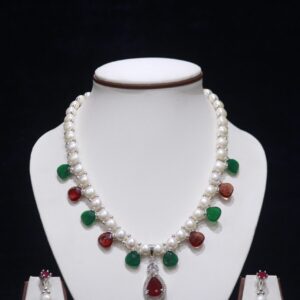 Pearl necklace set with ruby and emerald accents, offering a luxurious and vibrant touch to your jewelry collection.