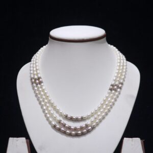 Three layered pearl necklace set with silver accents, offering a luxurious design for special occasions.