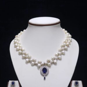 Two-layered pearl necklace set with blue stone pendant, showcasing elegant design with vibrant blue stone for a sophisticated look.