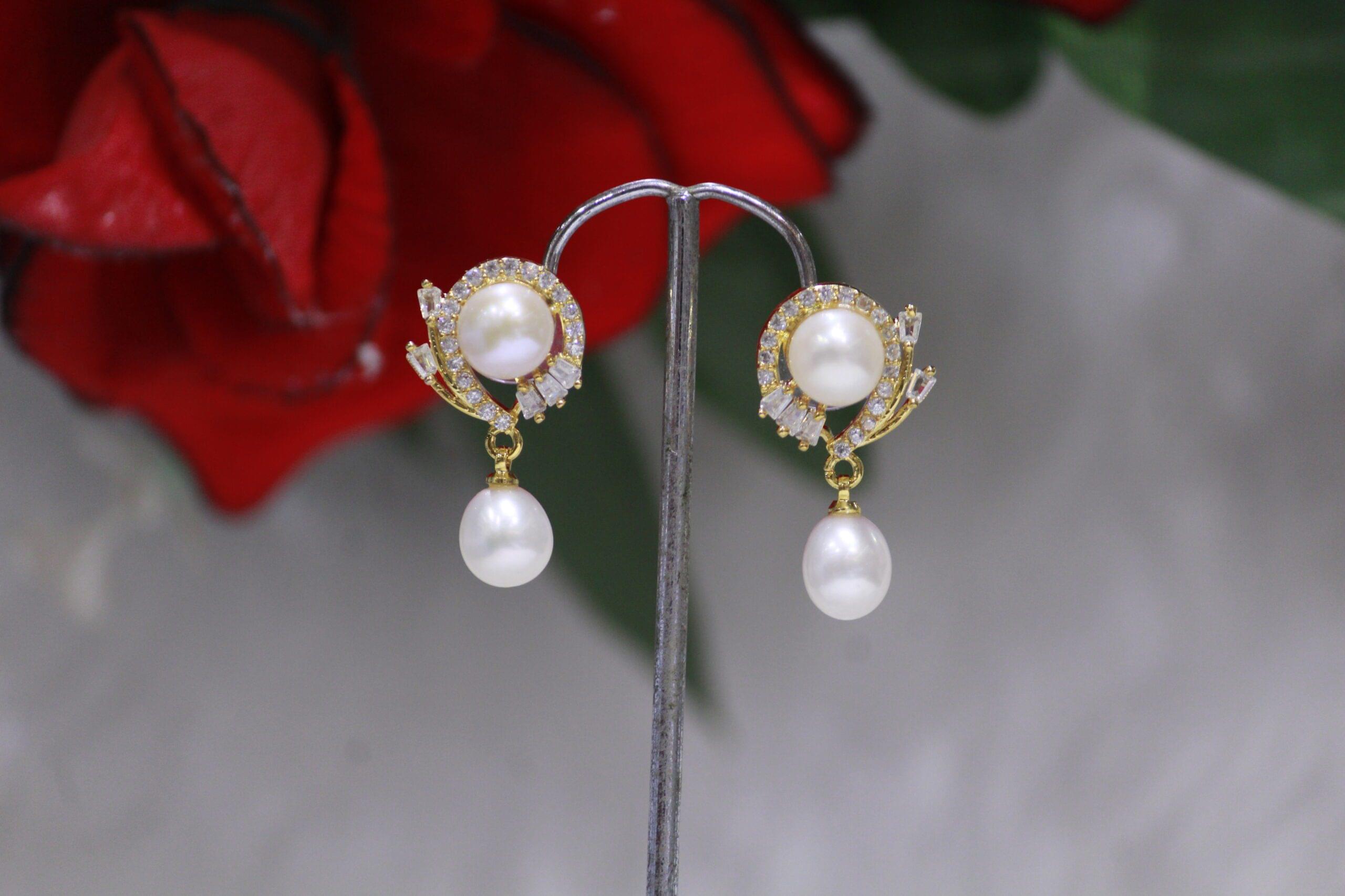 Pearl Drop Earrings with Crystal Leaf Design - Elegant pearl drops paired with a sparkling crystal leaf design for a timeless and nature-inspired look.