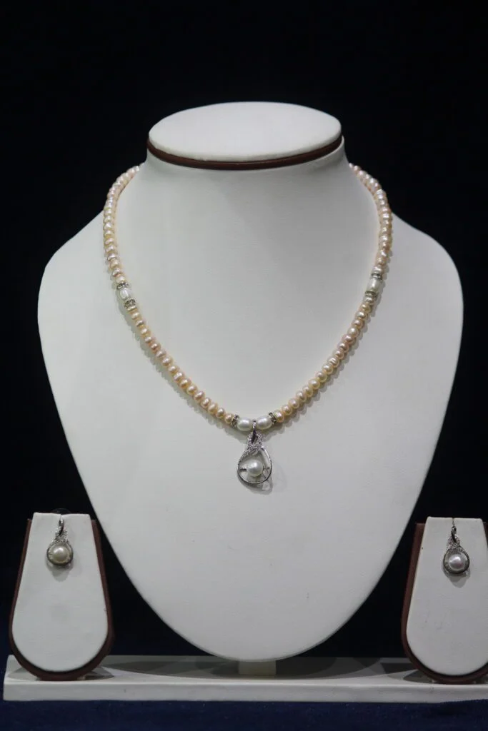 Pearl Necklace Set with Heart-Shaped Pendant - A stunning pearl necklace set featuring a delicate heart-shaped pendant, symbolizing love and elegance.
