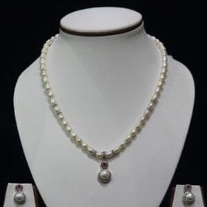 Pearl Necklace Set with Ruby Pendant - A luxurious pearl necklace set featuring a stunning ruby pendant for a sophisticated and elegant look.