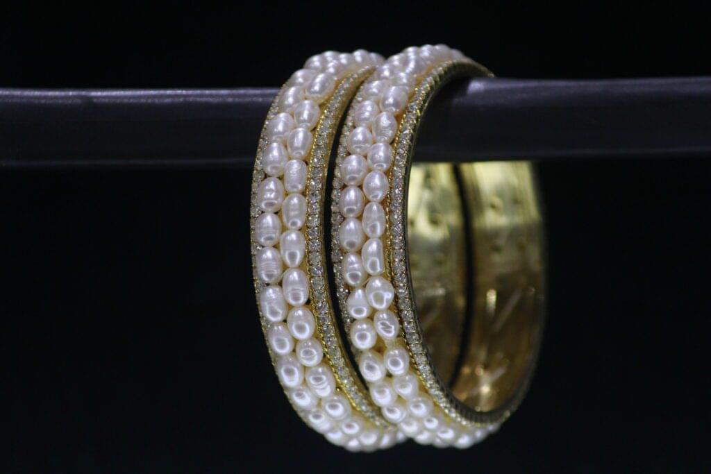 Luxury pearl bangle designed with radiant pearls and an elegant finish, offering a sophisticated touch to any outfit.