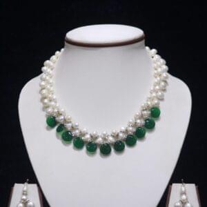 Pearl necklace set with green stone accents for a chic and vibrant look.