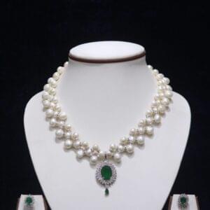 Elegant Pearl Necklace Set with Emerald Pendant, showcasing a timeless design of lustrous pearls and a vibrant green emerald pendant.