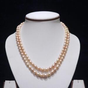Two-layered golden pearl necklace set featuring elegant pearls and a luxurious gold design.