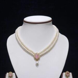 Two-layered pearl necklace set with a pink stone pendant, combining the timeless elegance of pearls with the delicate charm of a pink gemstone.