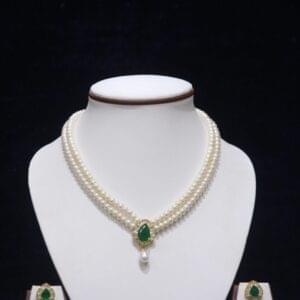 Two-layered pearl necklace set with an emerald pendant, featuring a perfect blend of classic pearls and a luxurious emerald accent.