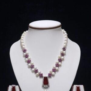 Elegant pearl necklace set with a stunning ruby pendant, perfect for adding a touch of luxury to any occasion.