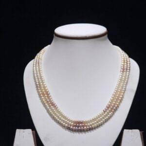 Three-layered multicolor pearl necklace set featuring vibrant pearls arranged in a stunning layered design for a sophisticated and unique look.